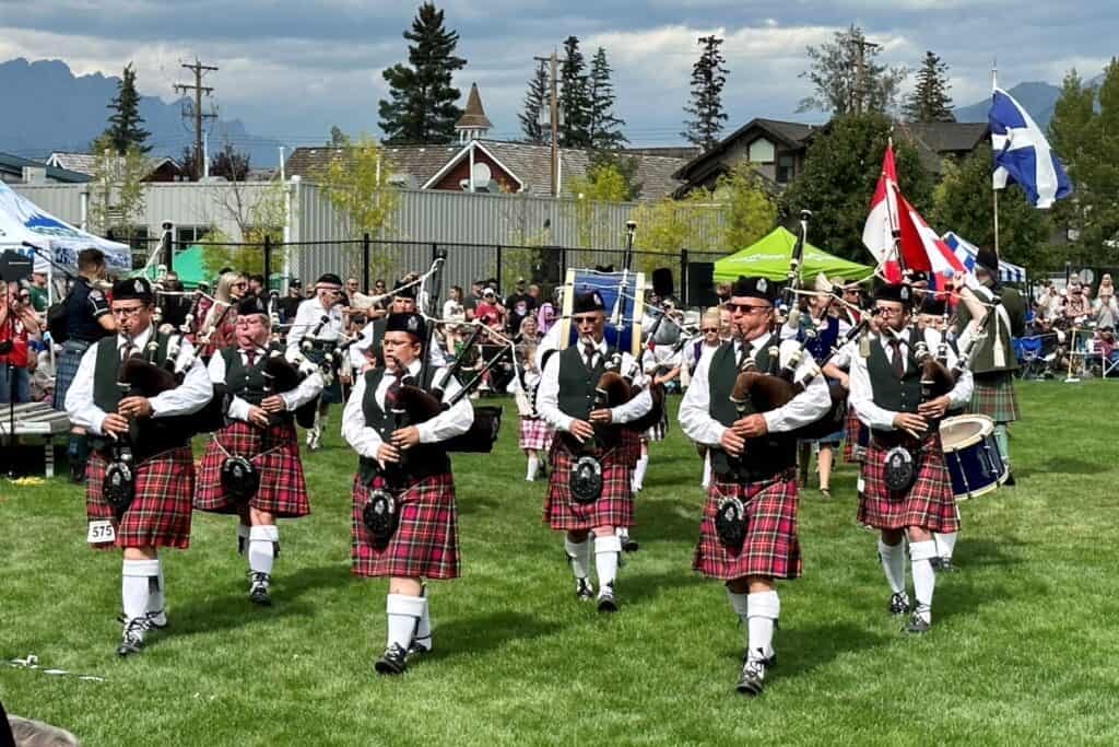 Scottish men in kilts play the bagpipes at canmore's highland games one of the unique things to do in canmore