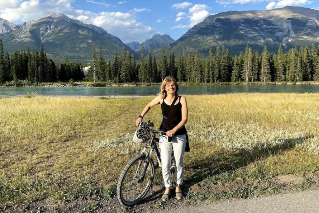Jill biking along the bow river in summer living in canmore alberta