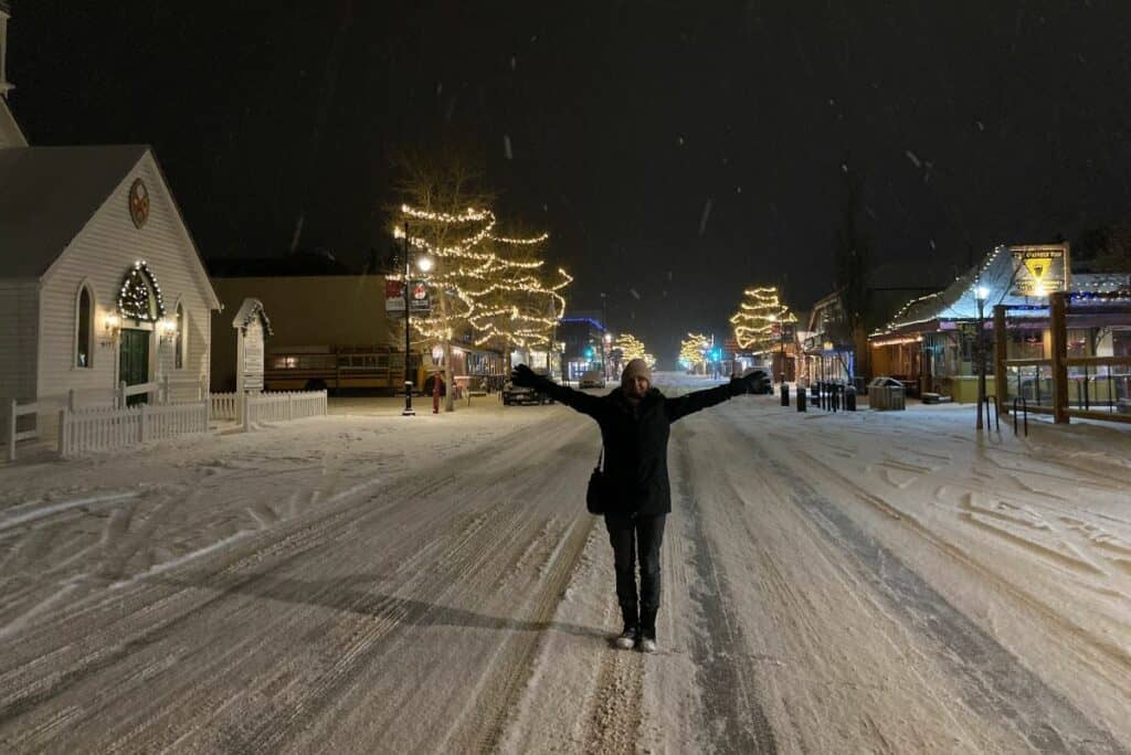 Jill standing on a snowy main street living in canmore alberta