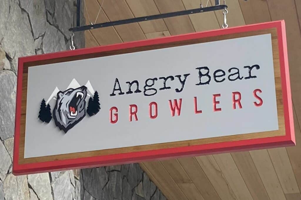A red and black sign for angry bear growlers one of the popular breweries in canmore alberta