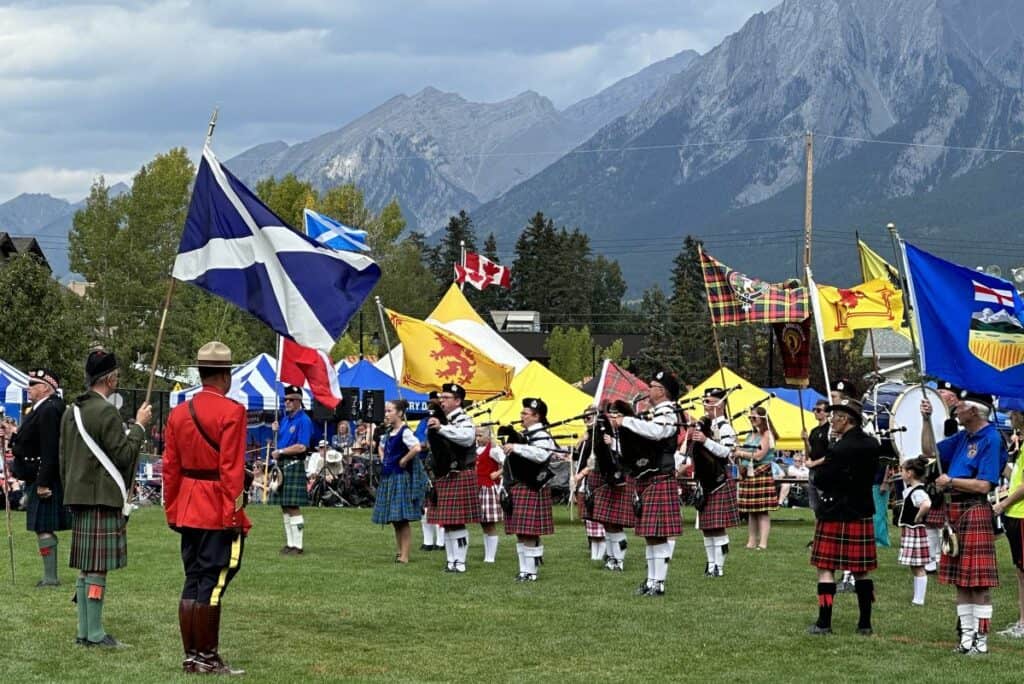 A bagpipe band at the canmore highland games represents the scottish heritage which inspired the canmore big head