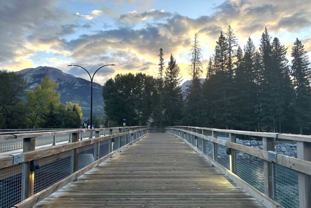 A view across canmore's road bridge at sunrise a popular start point for the bow river loop trail canmore