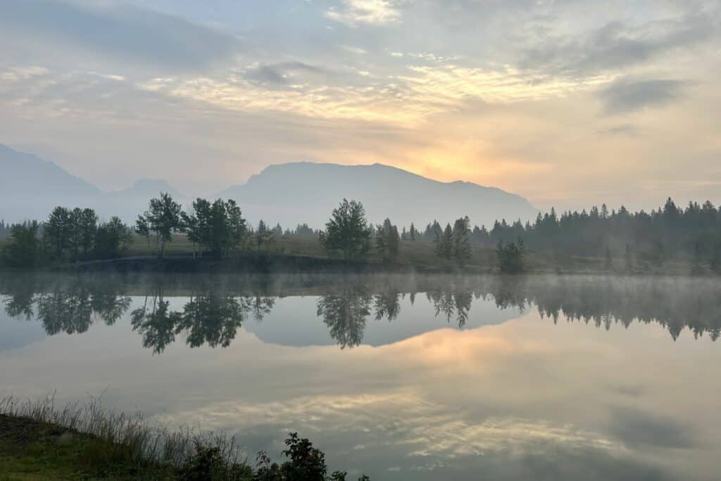 A misty sunrise over quarry lake canmore alberta in summer