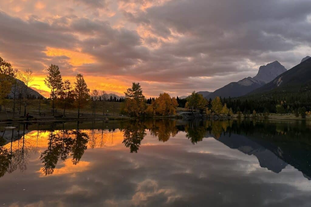 Orange and purple colours of a stunning sunrise over quarry lake canmore alberta
