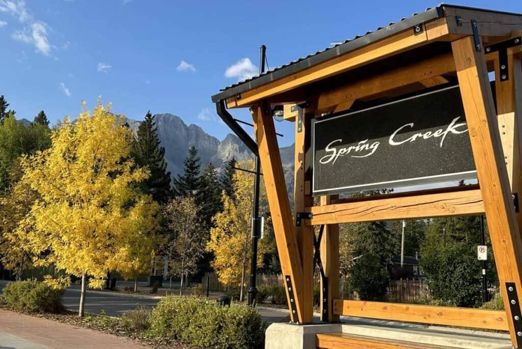 New spring creek residential development sign with fall trees living in canmore alberta