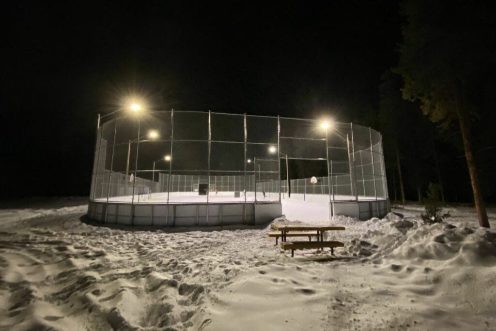 A floodlit larch ice rink in the snow things to do in canmore at night