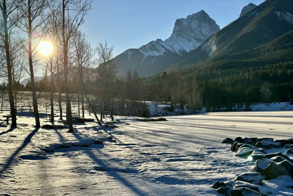 Early monring sun casts shadows over the picnic area on quarry lake loop canmore