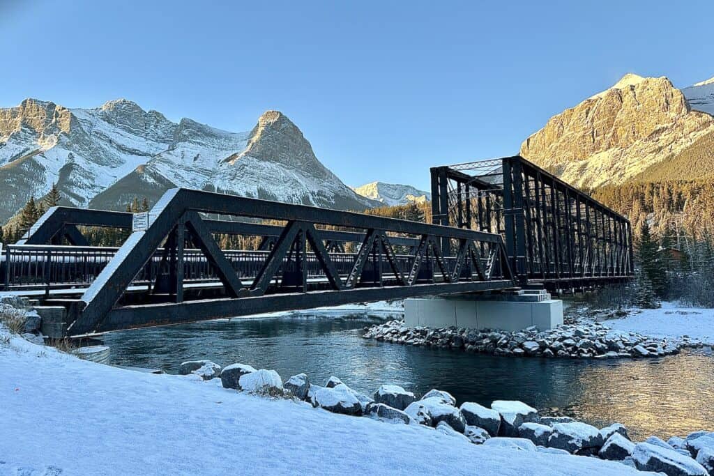 A wintery view of the mountain peaks at sunrise on the bow river loop trail canmore alberta