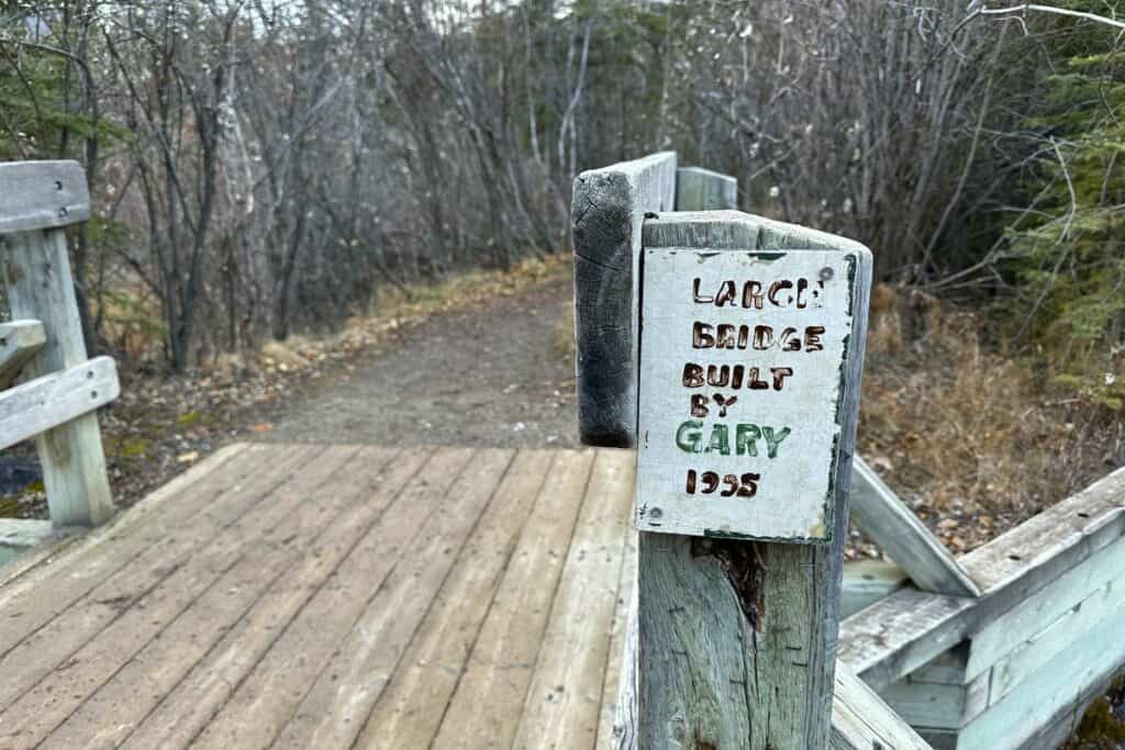 A sign showing who built the bridge to larch island interpetive trail canmore alberta