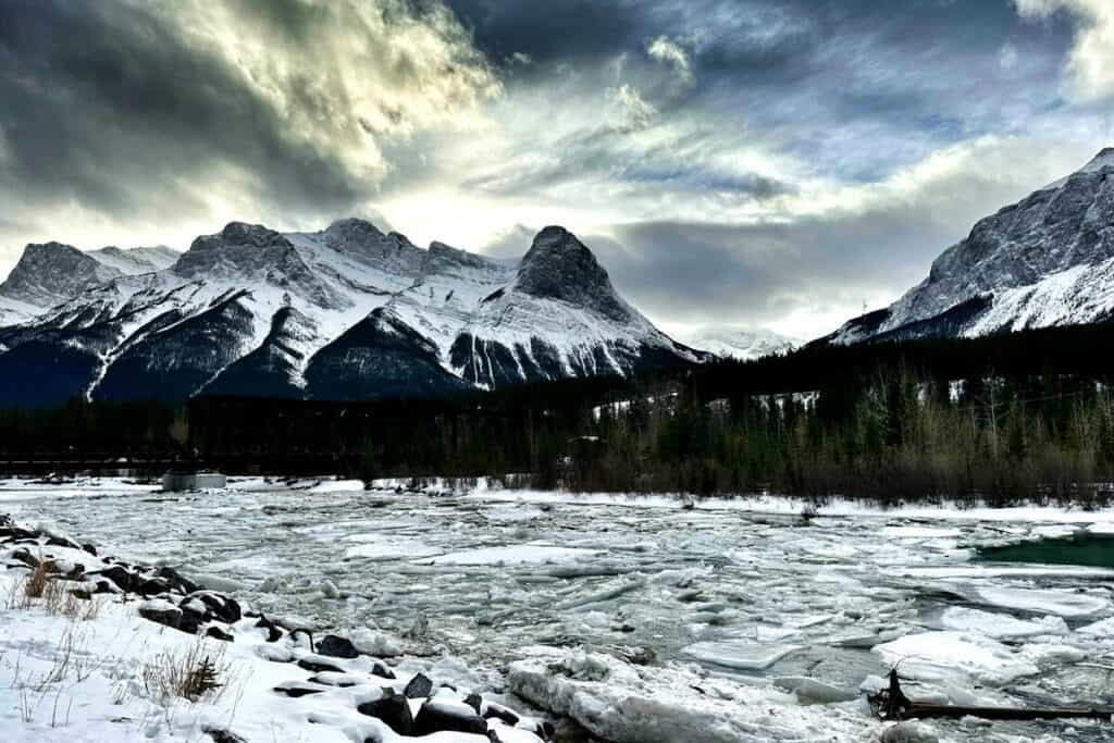 Large pieces of ice float down the bow river living in canmore alberta